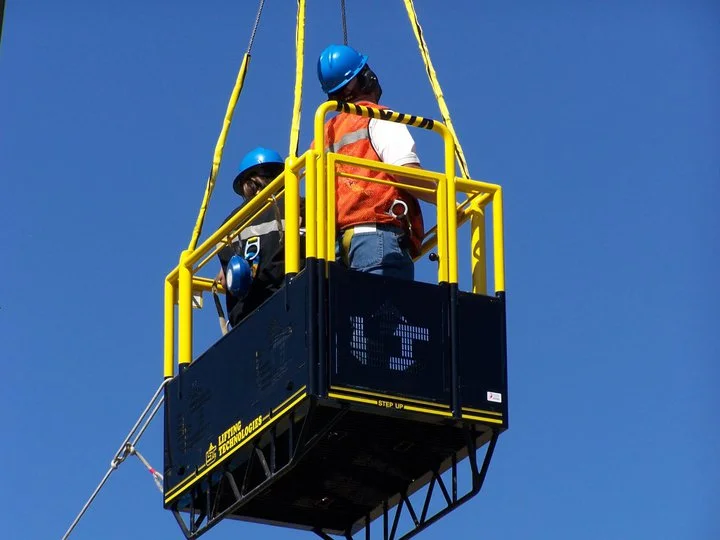 Worker in crane man basket at height