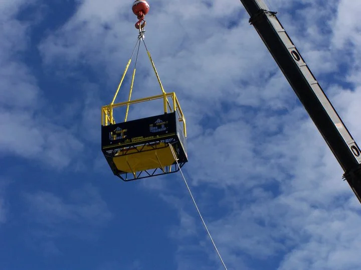 Man basket being lifted by crane