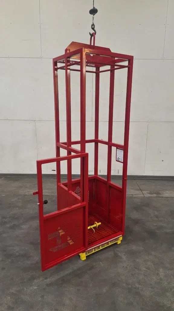 Engineered man basket with open door, interior grab rail, and internal test weight pin, designed for safe crane lifting in restricted environments.
