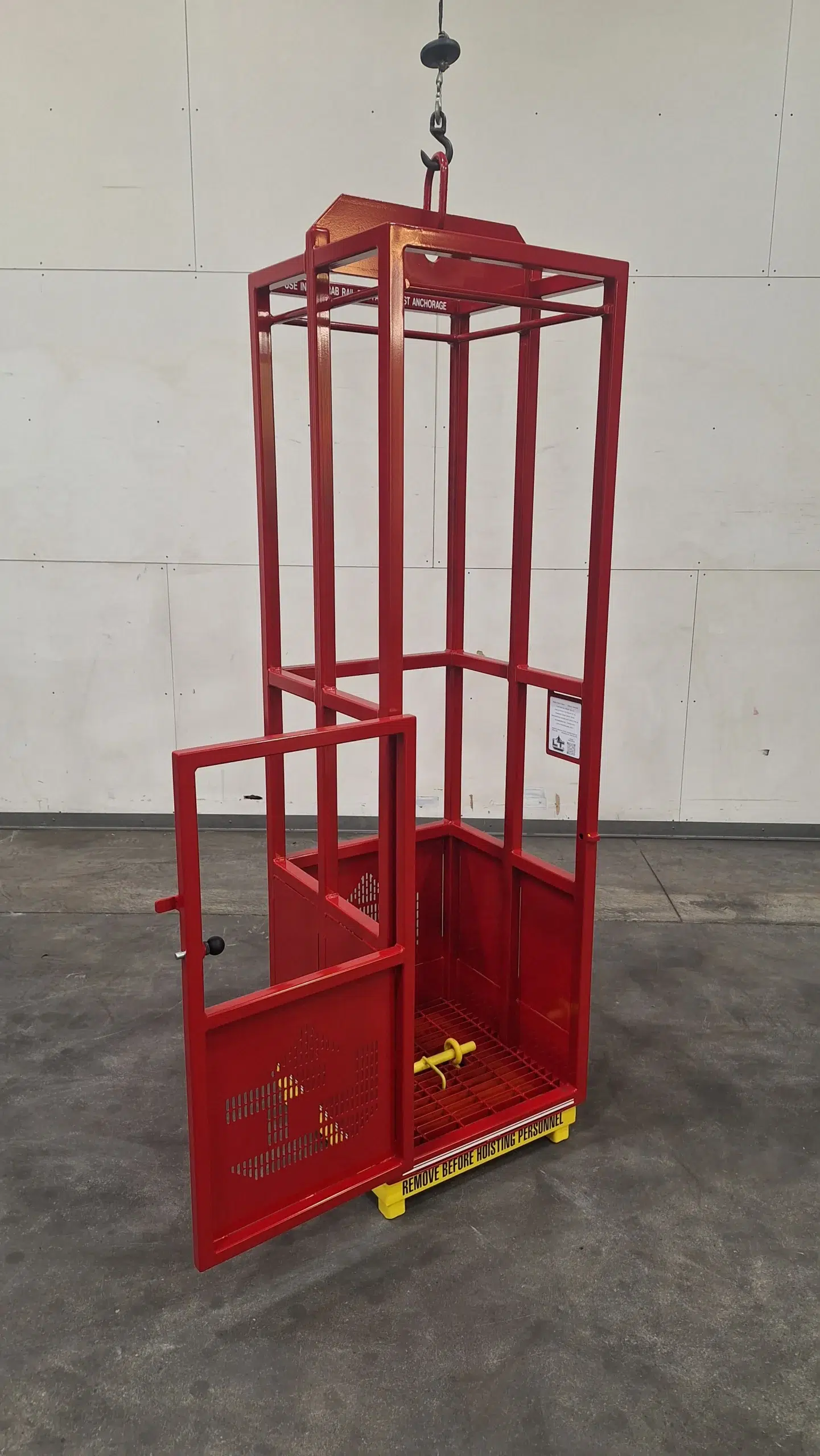 Engineered man basket with open door, interior grab rail, and internal test weight pin, designed for safe crane lifting in restricted environments.